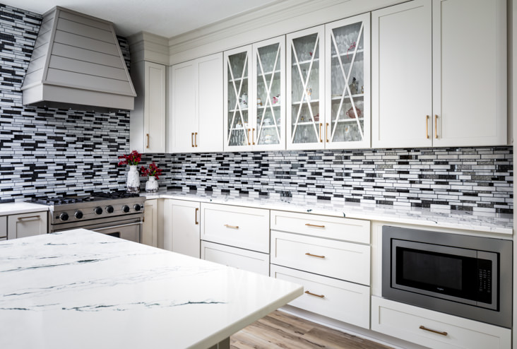 Superior cabinetry, tile back-splash, and countertops highlight this beautiful kitchen